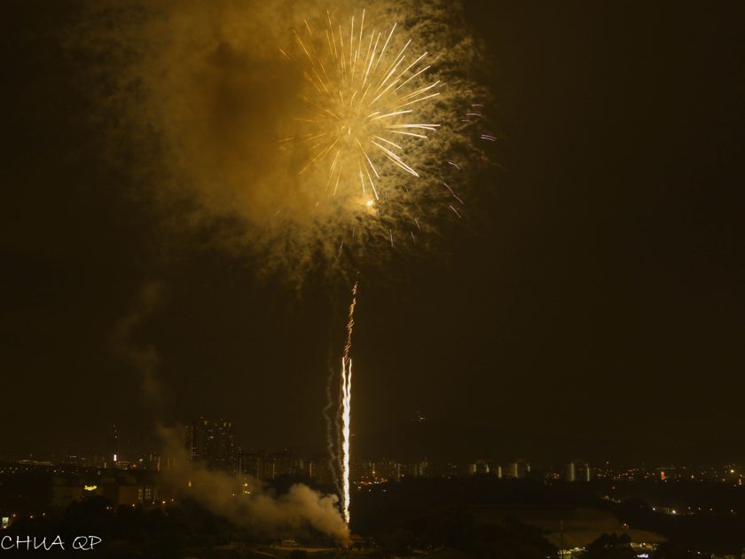 Golden fireworks lighting up a night sky